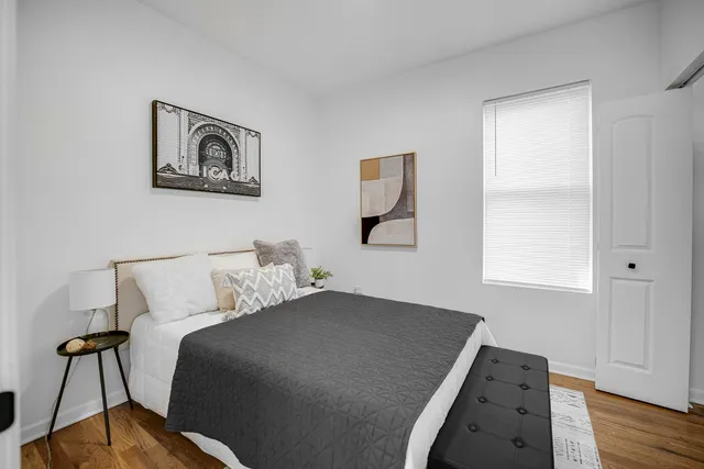 a bedroom with bed and night stand