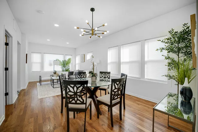 a view of a dining room with furniture window and wooden floor