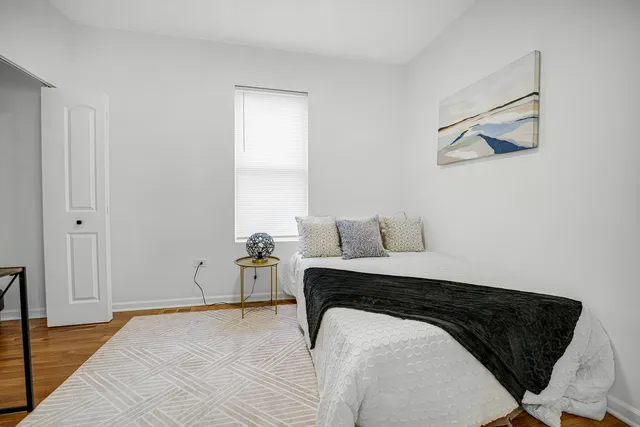 a bedroom with a bed and a chair