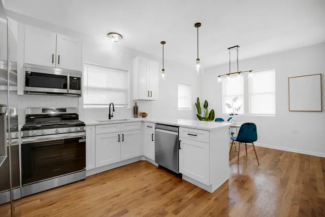 a kitchen with a stove a sink and a microwave