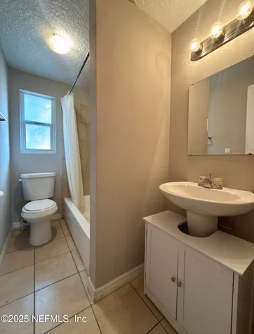 a view of bathroom with a toilet sink and mirror