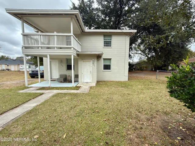 a view of a house with a yard and sitting area