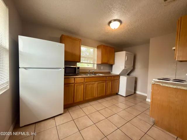 a kitchen with a refrigerator sink stove and cabinets