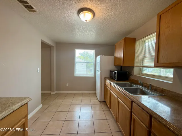 a kitchen with a sink a counter top space and appliances