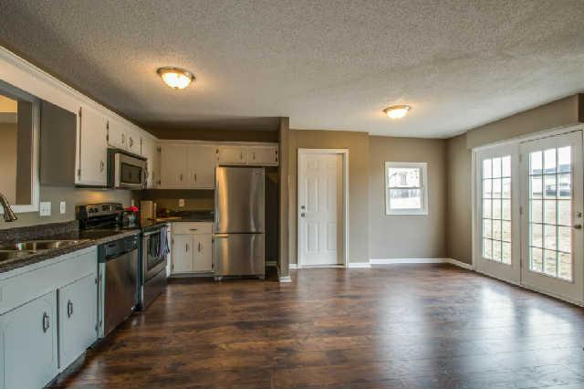 205 Ruf Drive Oak Grove, KY 42262 - Photo 5 of 20 a kitchen with a refrigerator a stove a sink dishwasher a oven with wooden cabinets and wooden floor