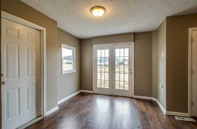 205 Ruf Drive Oak Grove, KY 42262 - Photo 6 of 20 an empty room with wooden floor and windows