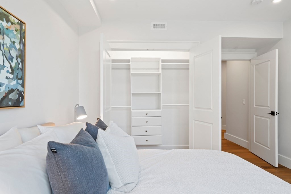 9 Glover Court, Unit 6 Boston, MA 02127 - Photo 16 of 34 a bedroom with a bed and a couch