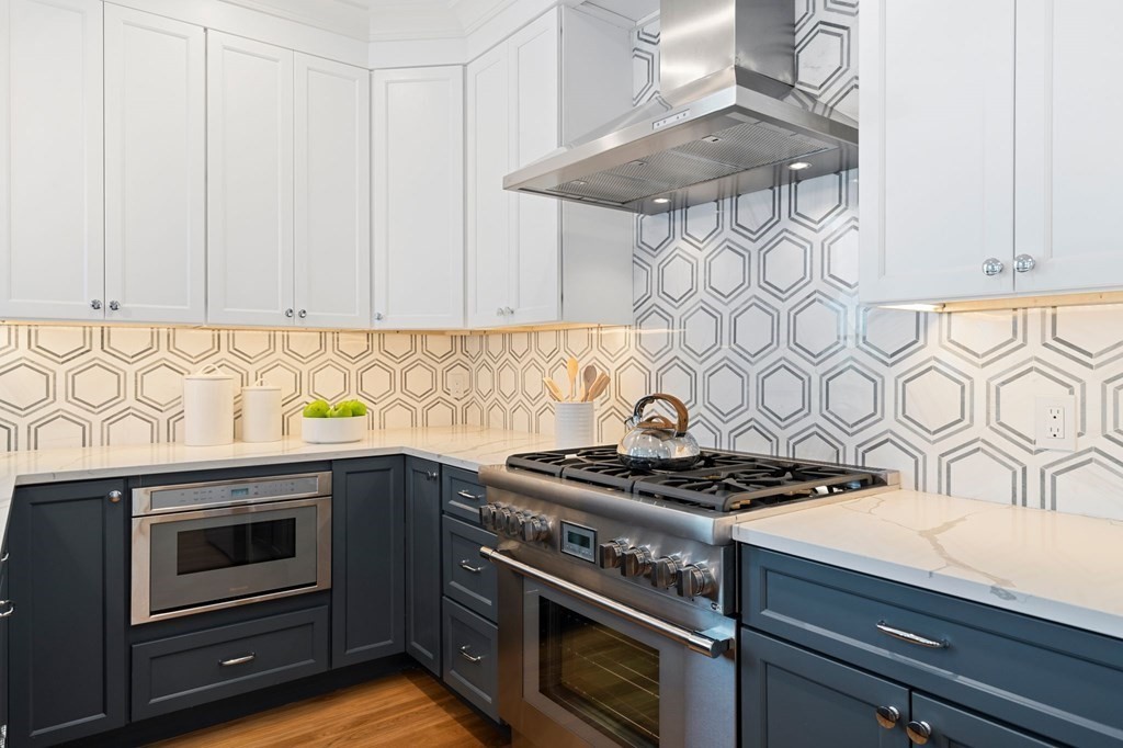 9 Glover Court, Unit 6 Boston, MA 02127 - Photo 2 of 34 a kitchen with granite countertop a stove and a sink