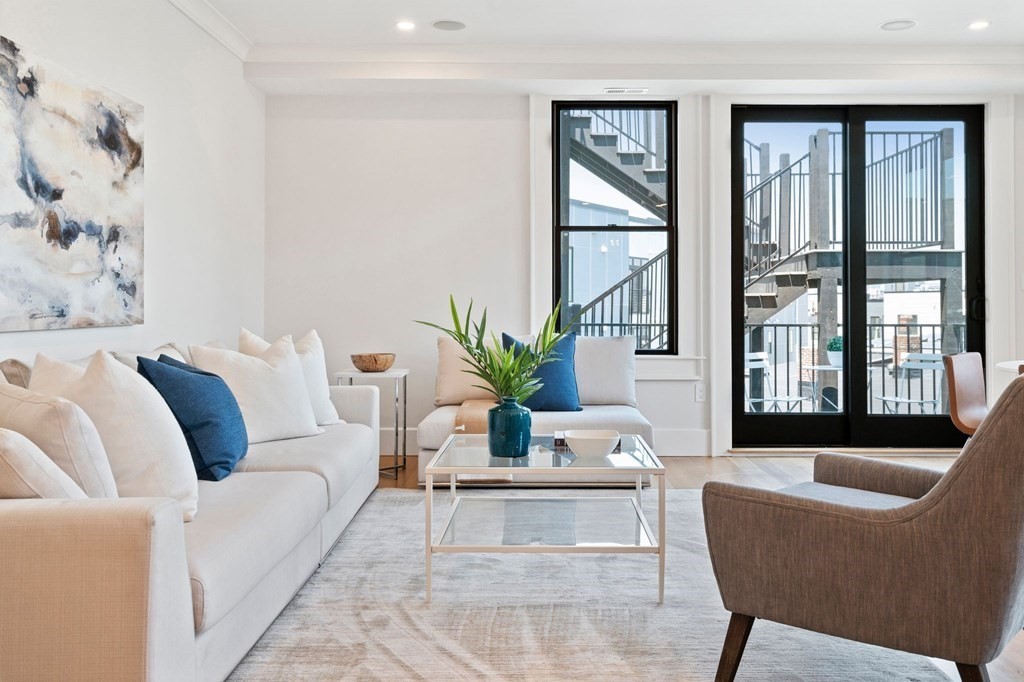 9 Glover Court, Unit 6 Boston, MA 02127 - Photo 10 of 34 a living room with furniture and floor to ceiling windows