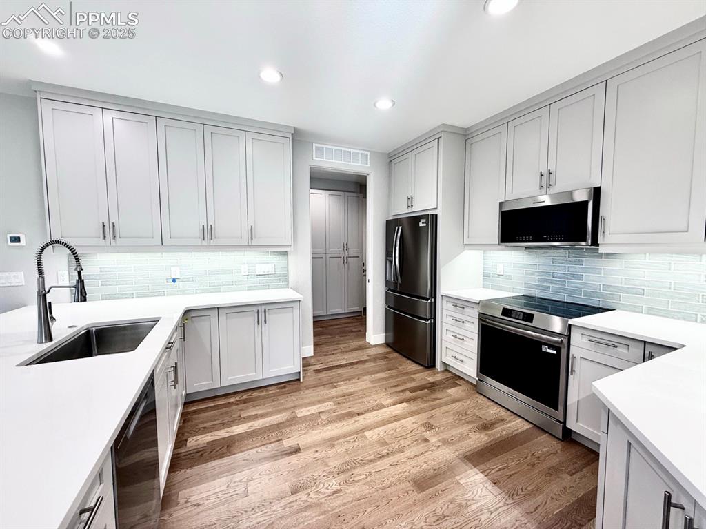 3155 Promise Point Colorado Springs, CO 80921 - Photo 9 of 26 a kitchen with stainless steel appliances granite countertop a sink stove and refrigerator
