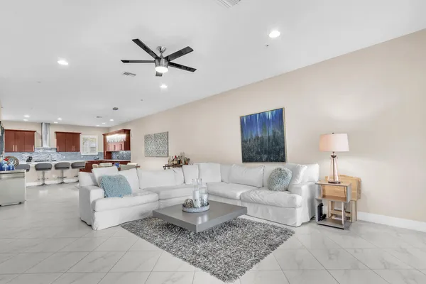 a living room with furniture and a dining table with chairs