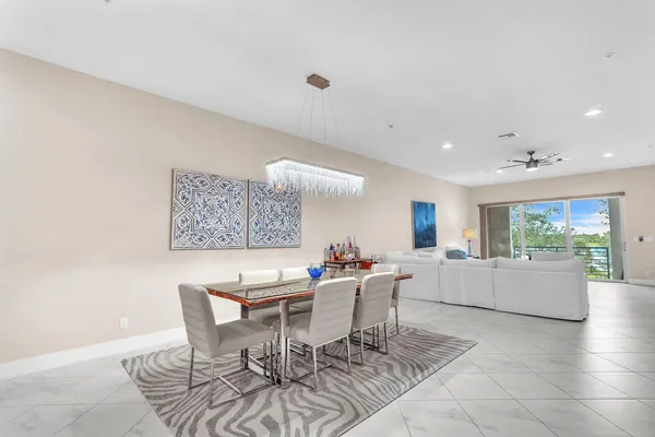 a living room with kitchen island furniture and a chandelier