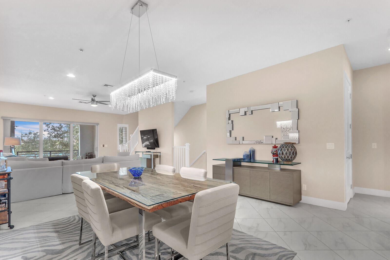 13332 Alton Road Palm Beach Gardens, FL 33418 - Photo 17 of 53 a living room with kitchen island furniture and a chandelier