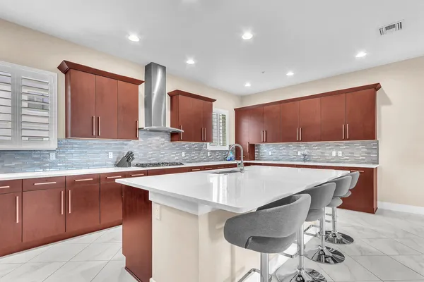 a kitchen with a sink stove and cabinets