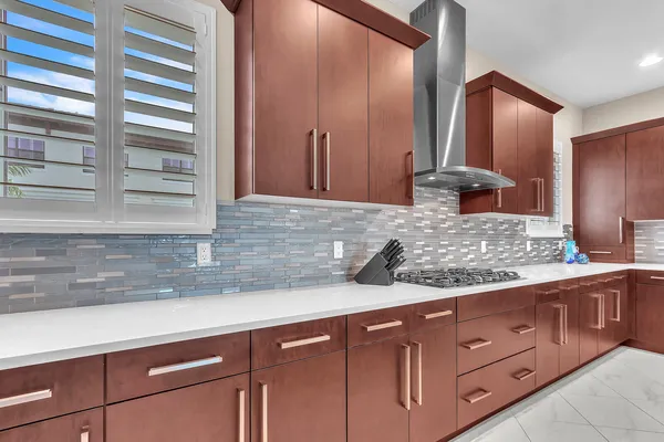 a kitchen with stainless steel appliances kitchen island granite countertop a sink and cabinets