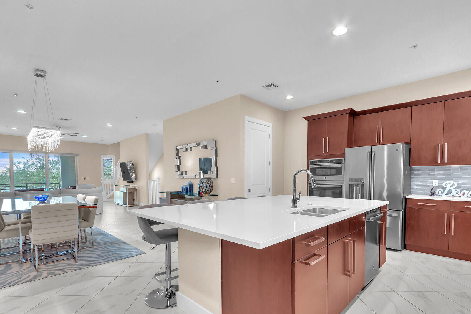 13332 Alton Road Palm Beach Gardens, FL 33418 - Photo 23 of 53 a kitchen with stainless steel appliances kitchen island granite countertop a sink and cabinets