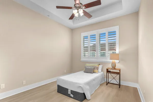 a bedroom with a large bed and a chandelier