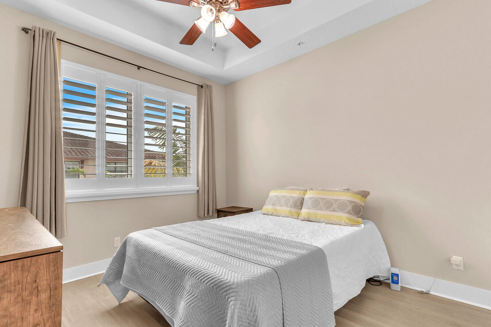 13332 Alton Road Palm Beach Gardens, FL 33418 - Photo 37 of 53 a bedroom with a large bed and a chandelier