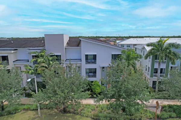 an aerial view of residential building with green space