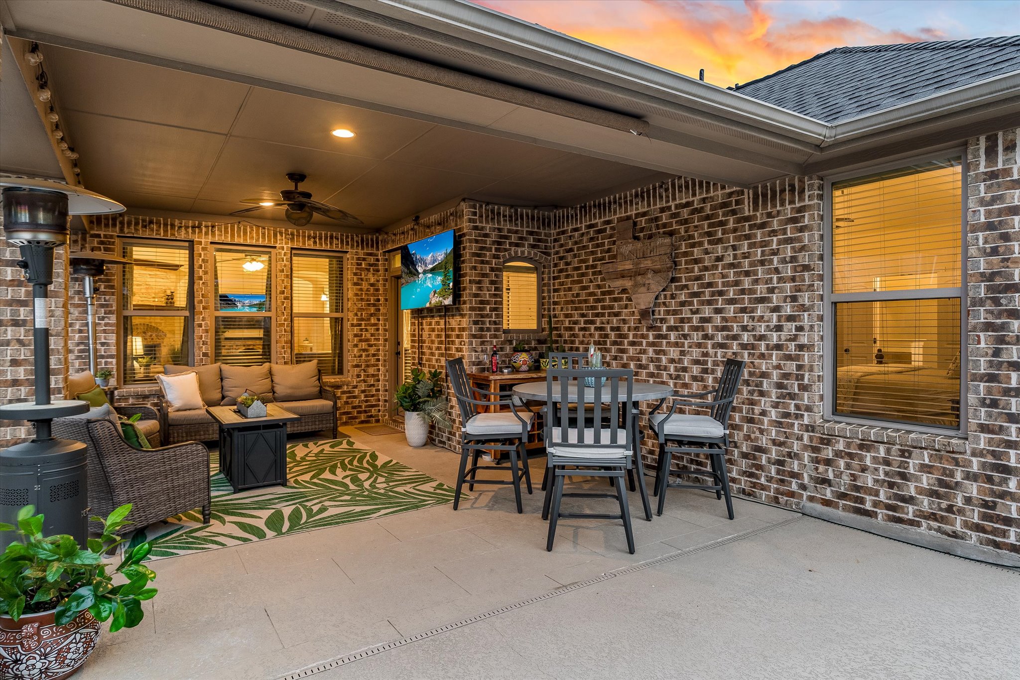 226 Galloway Lane Austin, TX 78737 - Photo 26 of 30 Patio terrace at dusk featuring an outdoor living / dining area, ceiling fan, a patio area, and a grill