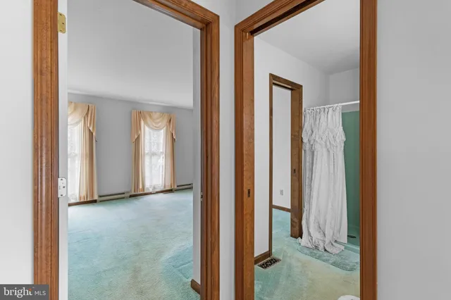 an empty room with windows and closet