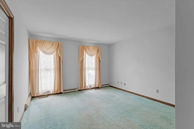 an empty room with closet and mirrors