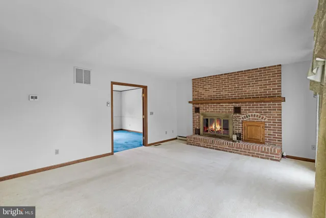 an empty room with fireplace