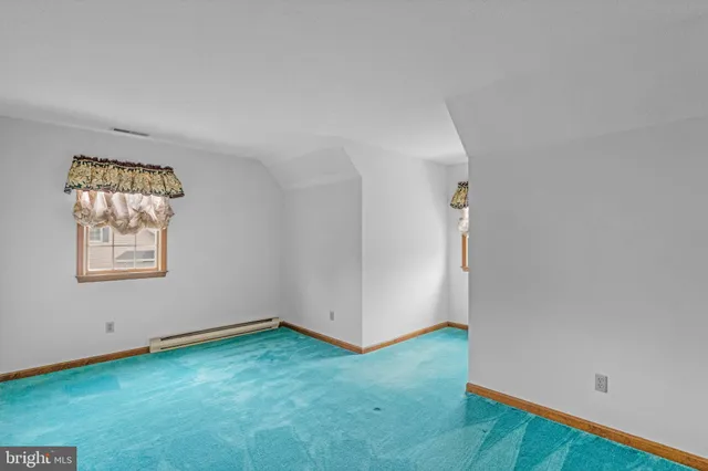 an empty room with closet and a bathroom