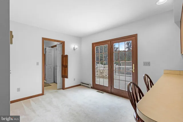 a view of a kitchen with furniture and refrigerator