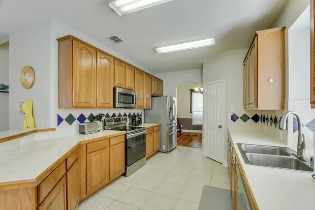 a kitchen with a sink stove and cabinets