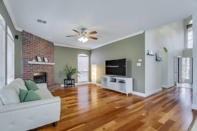 a living room with furniture fireplace and a flat screen tv