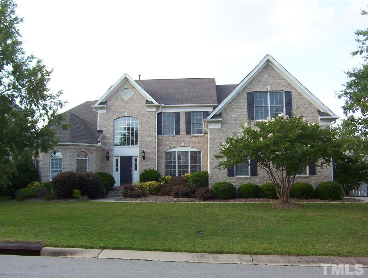 10652 Tarton Fields Circle Raleigh, NC 27617 - Photo 1 of 25 a front view of a house with a yard and potted plants