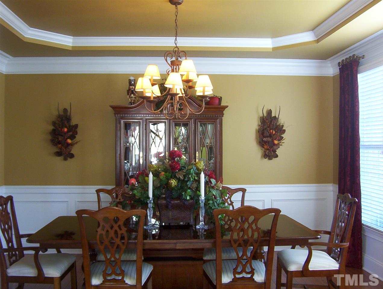 10652 Tarton Fields Circle Raleigh, NC 27617 - Photo 2 of 25 a view of a dining room with furniture and chandelier
