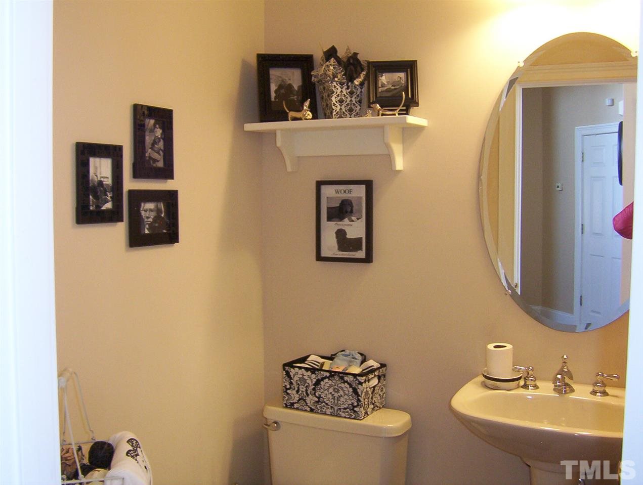 10652 Tarton Fields Circle Raleigh, NC 27617 - Photo 14 of 25 a bathroom with a sink and a mirror