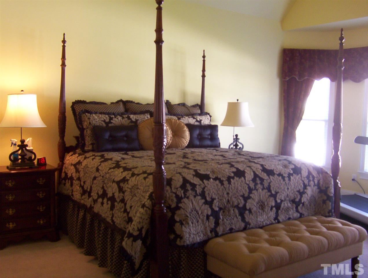 10652 Tarton Fields Circle Raleigh, NC 27617 - Photo 15 of 25 a bed room with a bed window and lamp