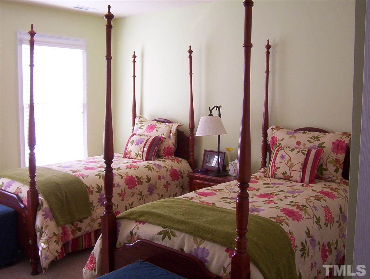 10652 Tarton Fields Circle Raleigh, NC 27617 - Photo 19 of 25 a bedroom with two beds and large window