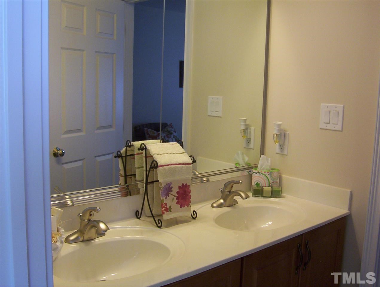 10652 Tarton Fields Circle Raleigh, NC 27617 - Photo 20 of 25 a bathroom with a sink and a mirror