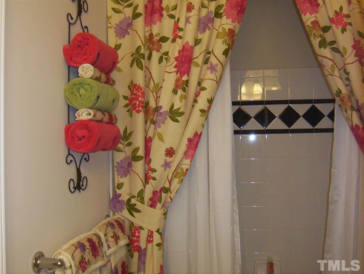10652 Tarton Fields Circle Raleigh, NC 27617 - Photo 22 of 25 a bathroom with a sink mirror and vanity
