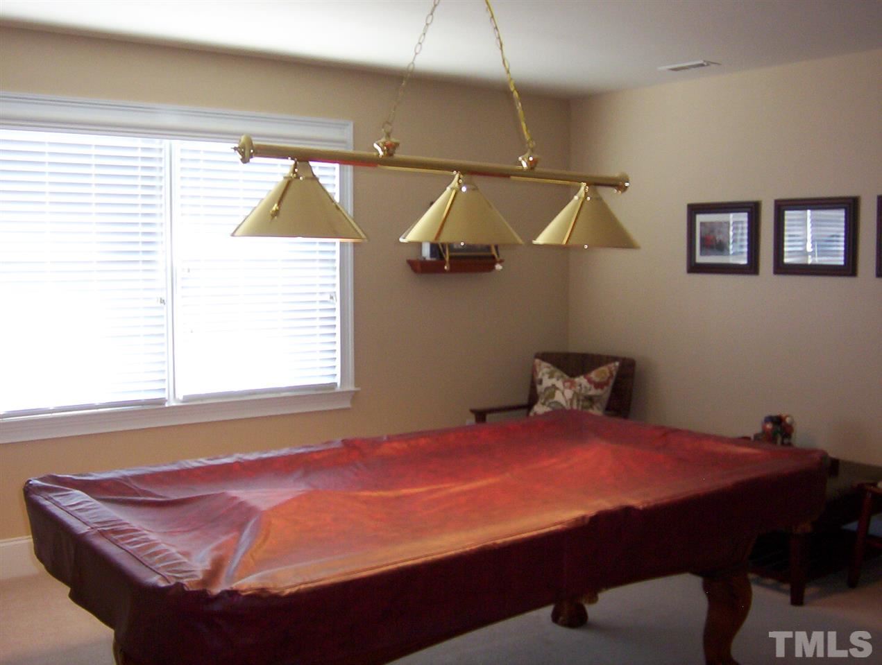 10652 Tarton Fields Circle Raleigh, NC 27617 - Photo 24 of 25 a bedroom with a bed and window