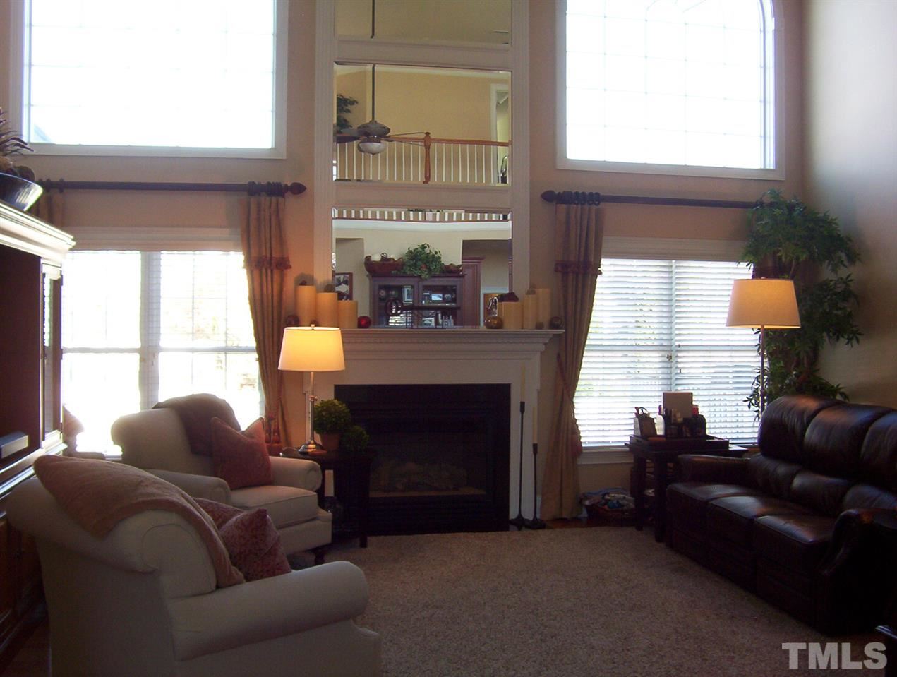 10652 Tarton Fields Circle Raleigh, NC 27617 - Photo 9 of 25 a living room with furniture and a fireplace