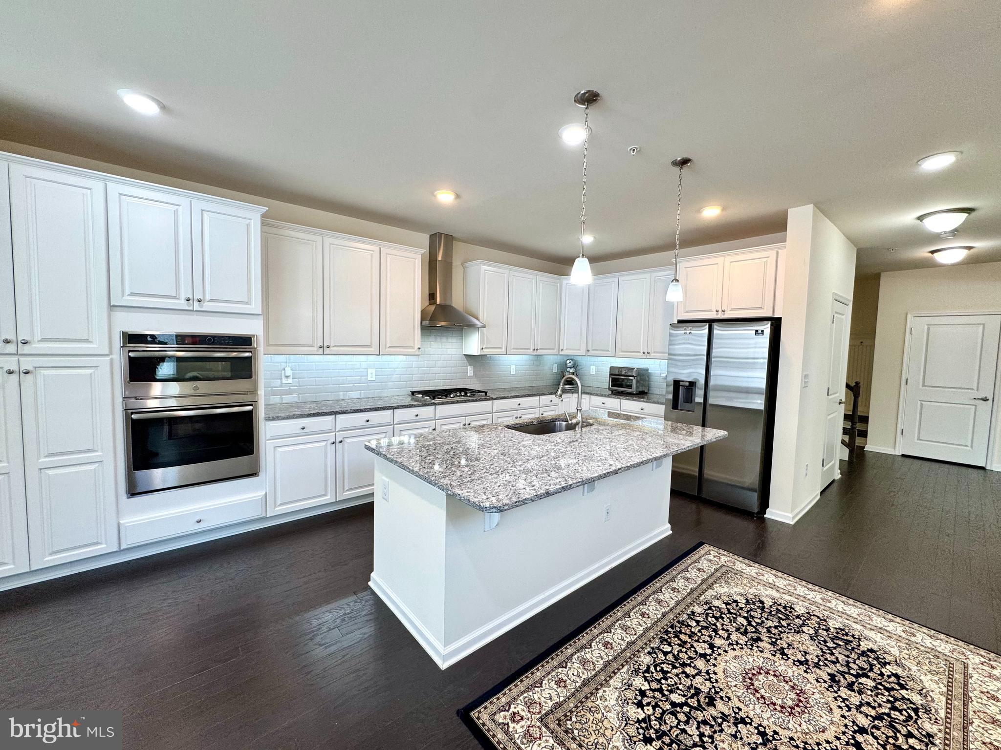 447 Lee Place Exton, PA 19341 - Photo 12 of 31 a kitchen with stainless steel appliances granite countertop a stove a sink and a refrigerator