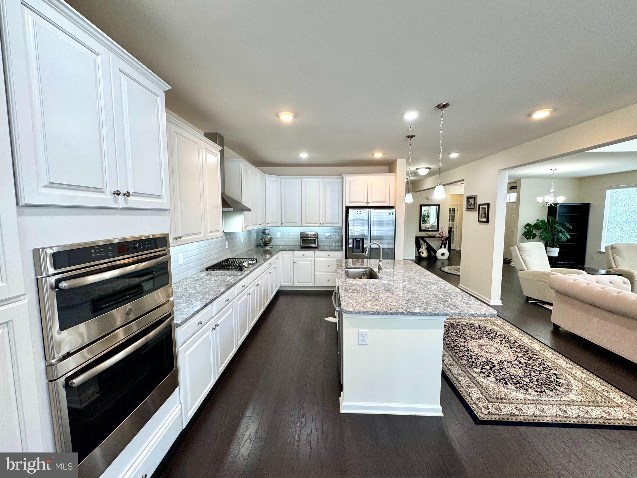 447 Lee Place Exton, PA 19341 - Photo 13 of 31 a large kitchen with kitchen island white cabinets and stainless steel appliances