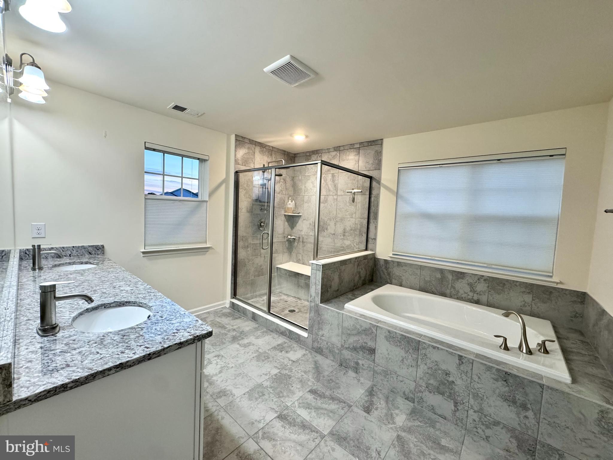 447 Lee Place Exton, PA 19341 - Photo 20 of 31 a spacious bathroom with a granite countertop tub sink and mirror
