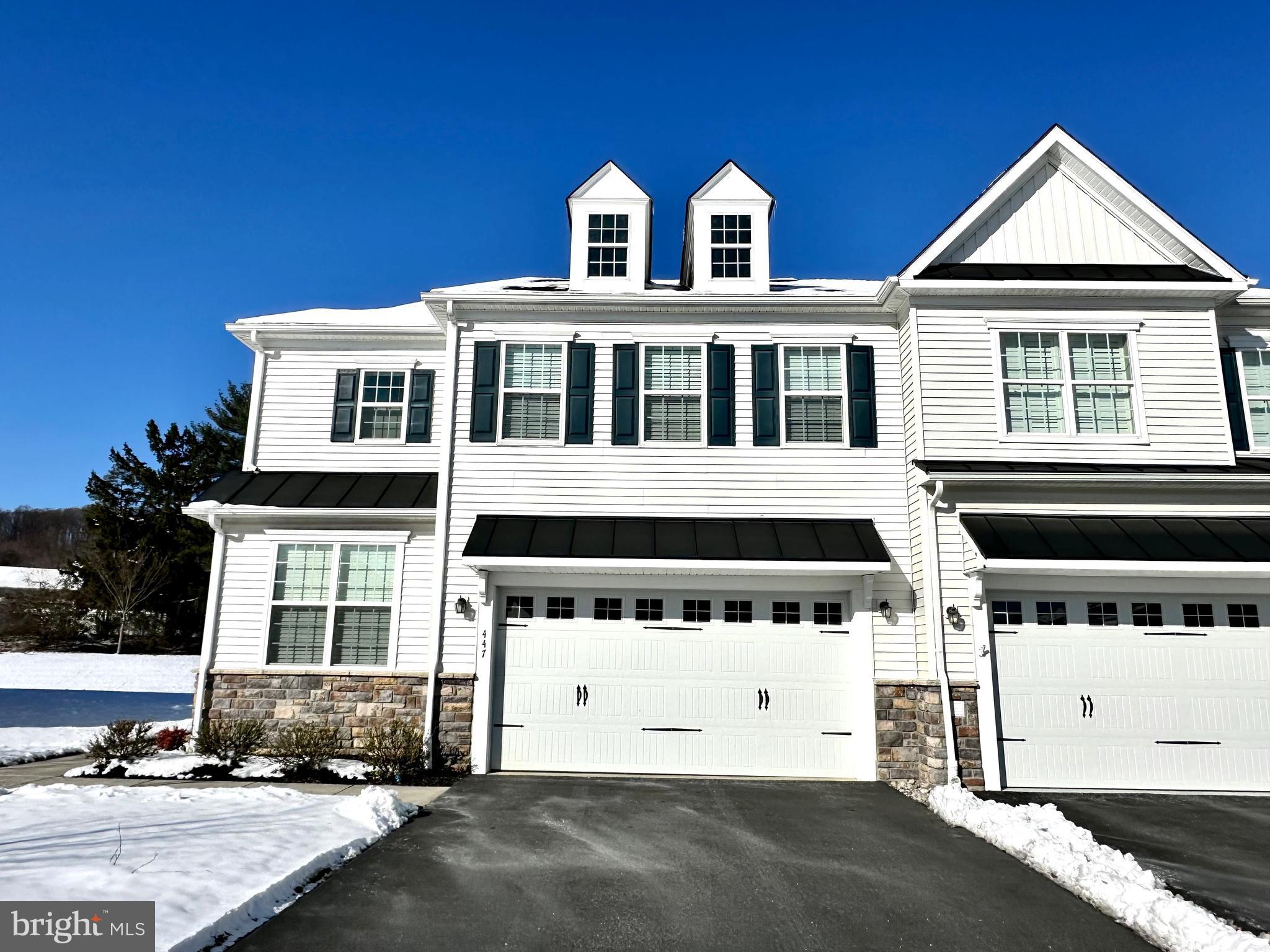 447 Lee Place Exton, PA 19341 - Photo 2 of 31 a front view of a house with a garage