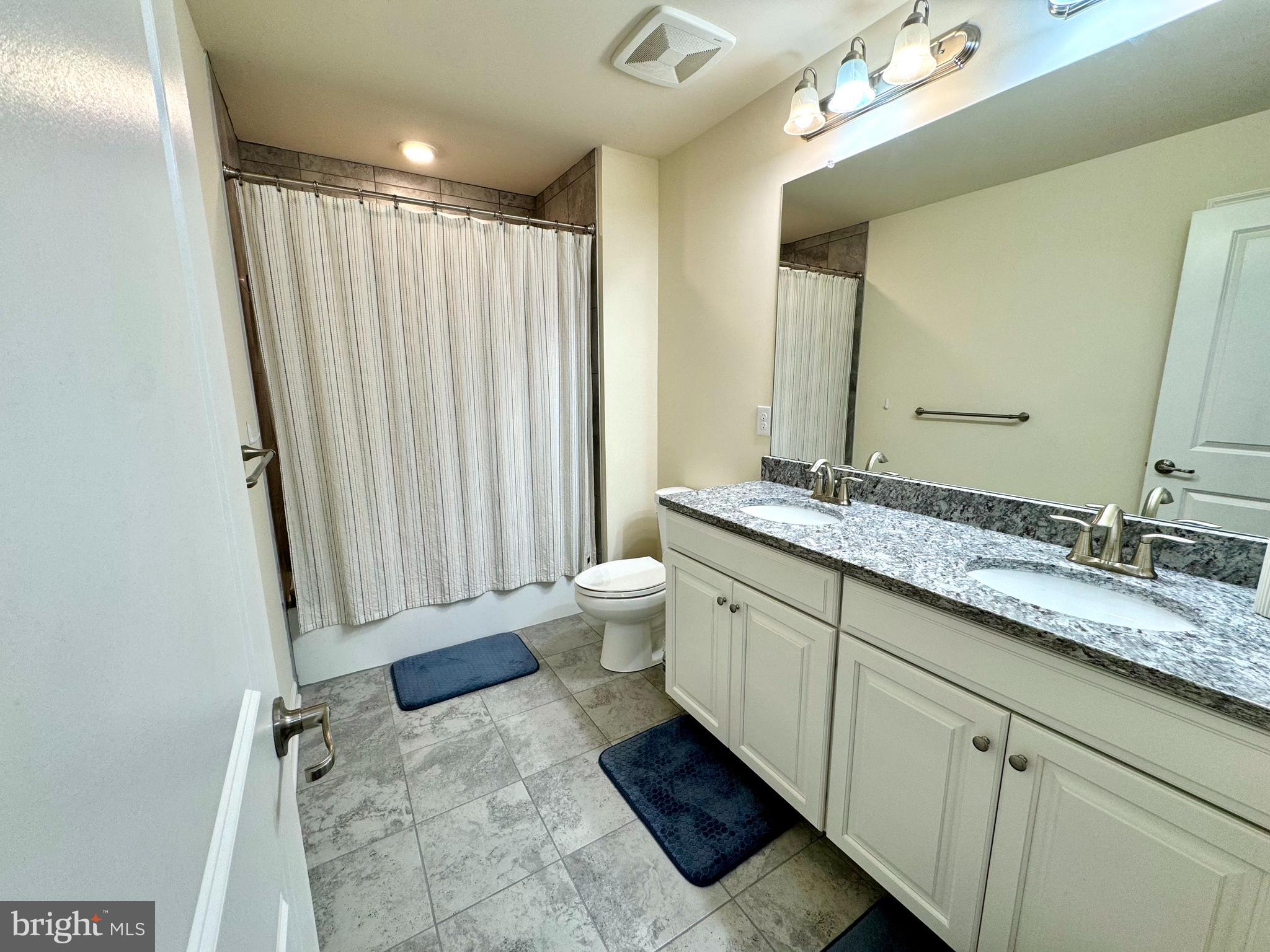 447 Lee Place Exton, PA 19341 - Photo 25 of 31 a bathroom with a granite countertop sink toilet and shower