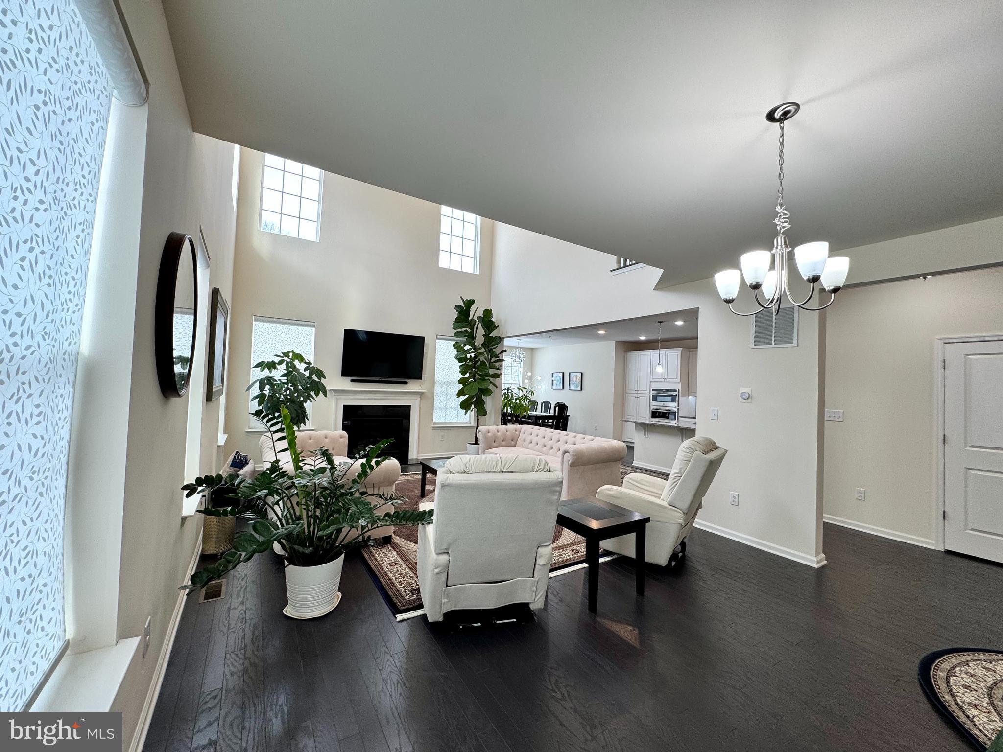 447 Lee Place Exton, PA 19341 - Photo 4 of 31 a view of a dining room with furniture a chandelier and wooden floor