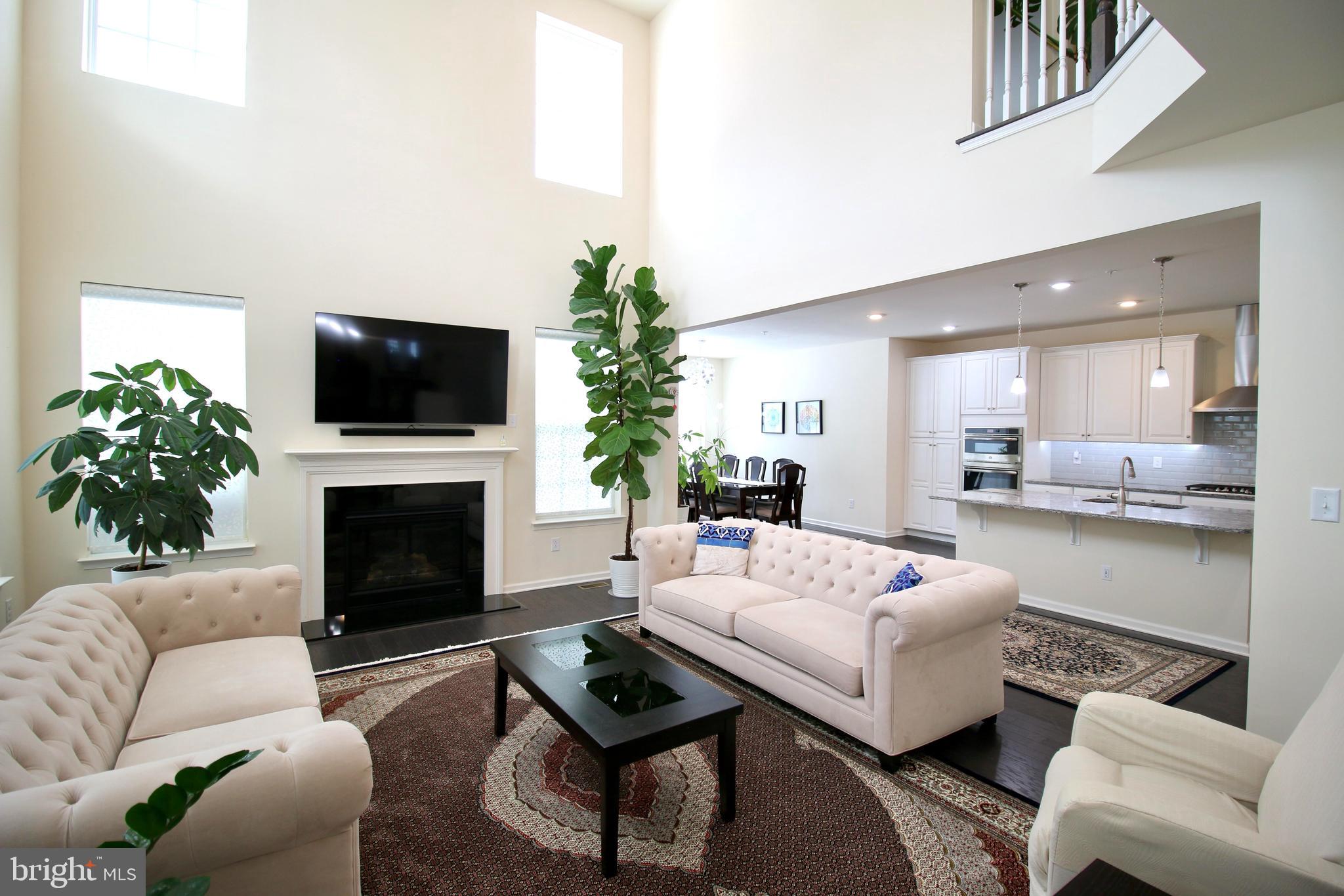 447 Lee Place Exton, PA 19341 - Photo 6 of 31 a living room with furniture a fireplace and a flat screen tv