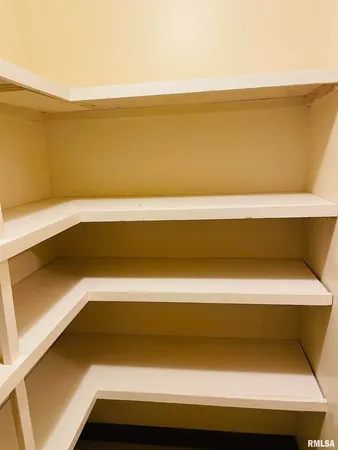 a view of an empty room with closet area