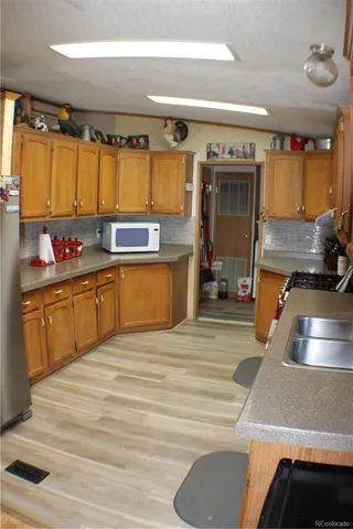 a kitchen with a sink stove and cabinets