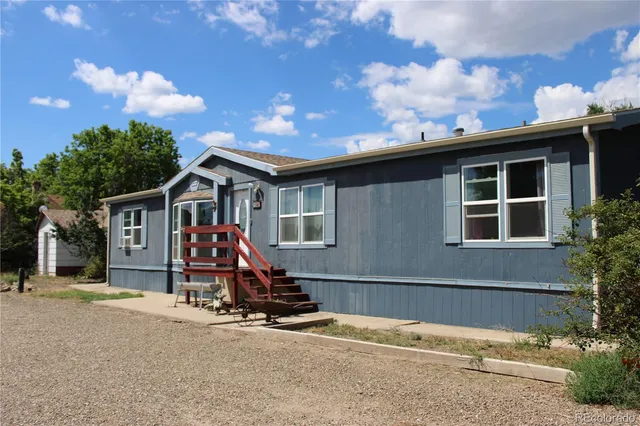 a view of a house with wooden floor and fence